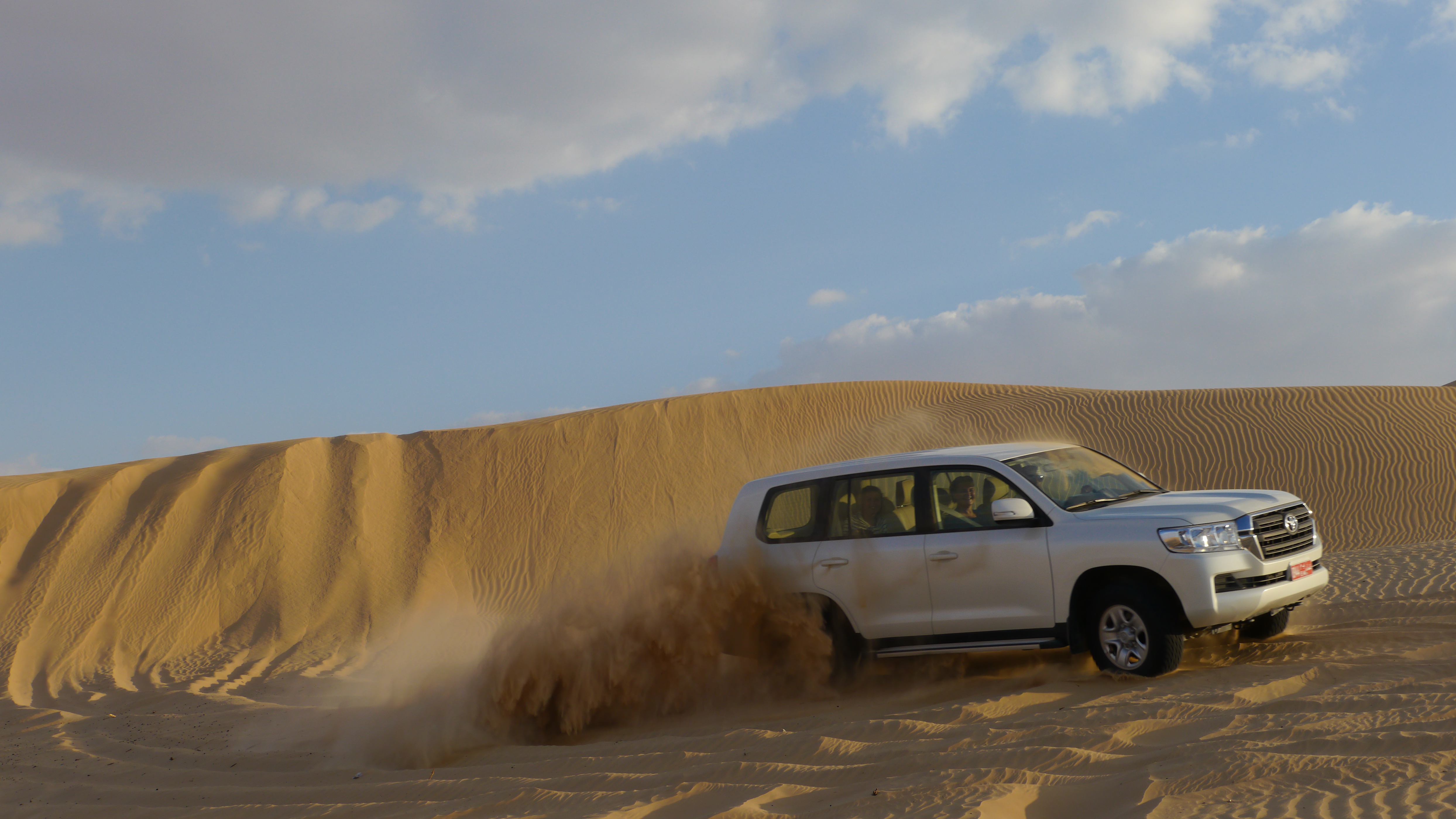 Riding the dunes in off-road cars is much fun. Trip from Salalah to the Empty Quarter desert.