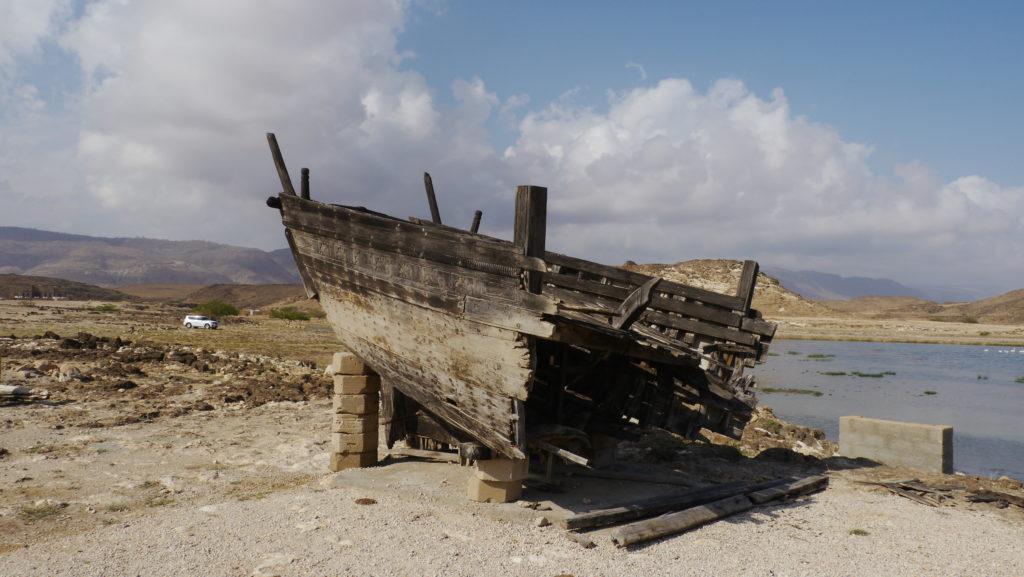 The remains of sambuq Dhib ship lie on the coast of lagoon Khor Rori under the ruins of Samharam Unesco site. Salalah East trip.