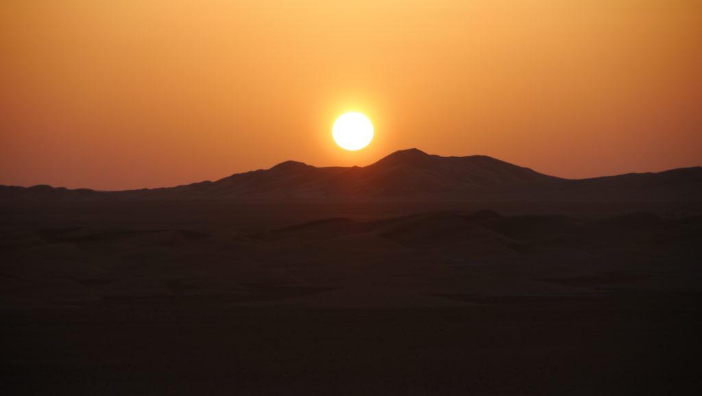 Rub al-Khali, Empty Quarter desert. Sun setting over the dunes. Desert overnight trip from Salalah.