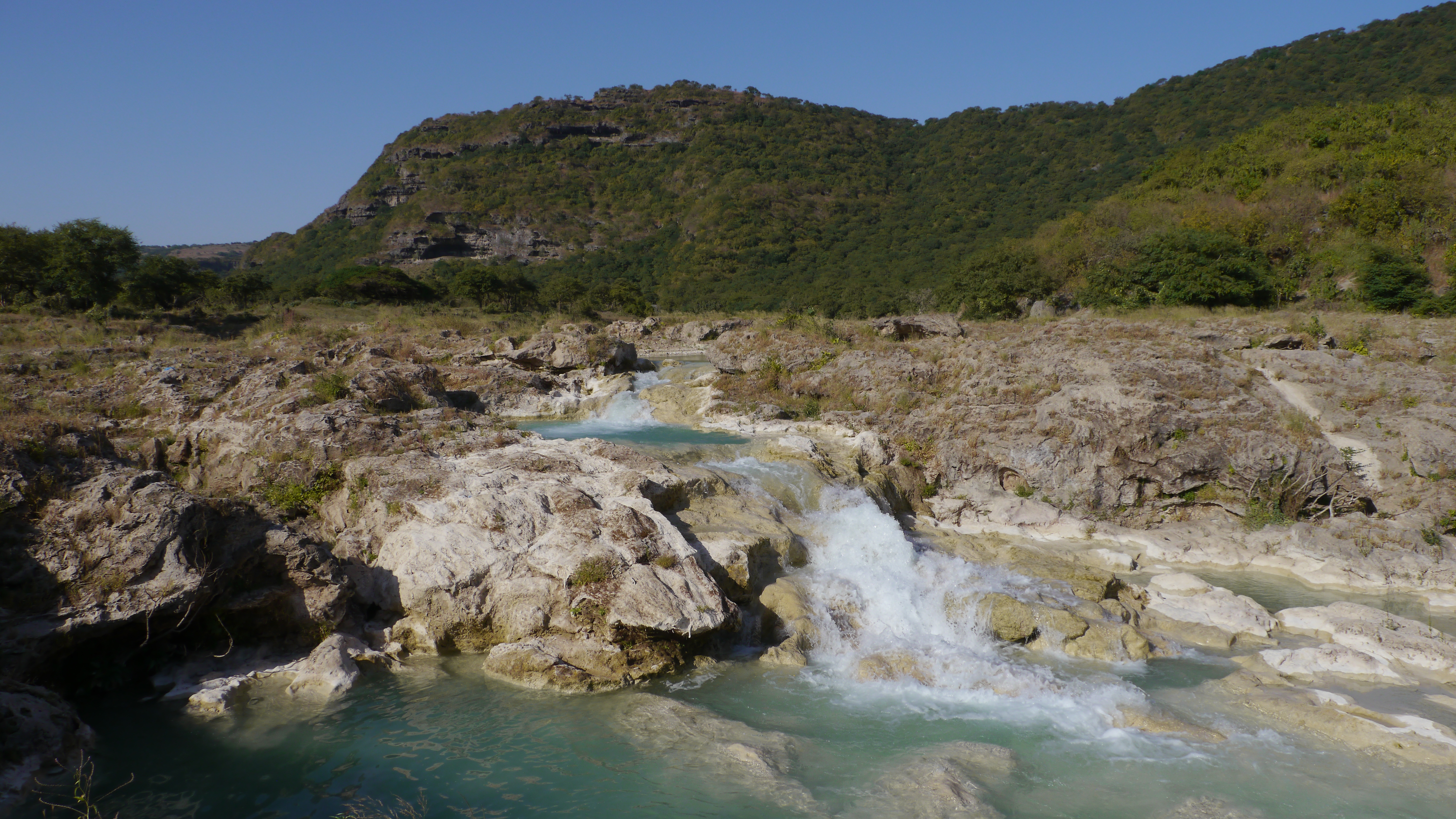 Wadi darbat azure waters running to the waterfall. East of salalah trip